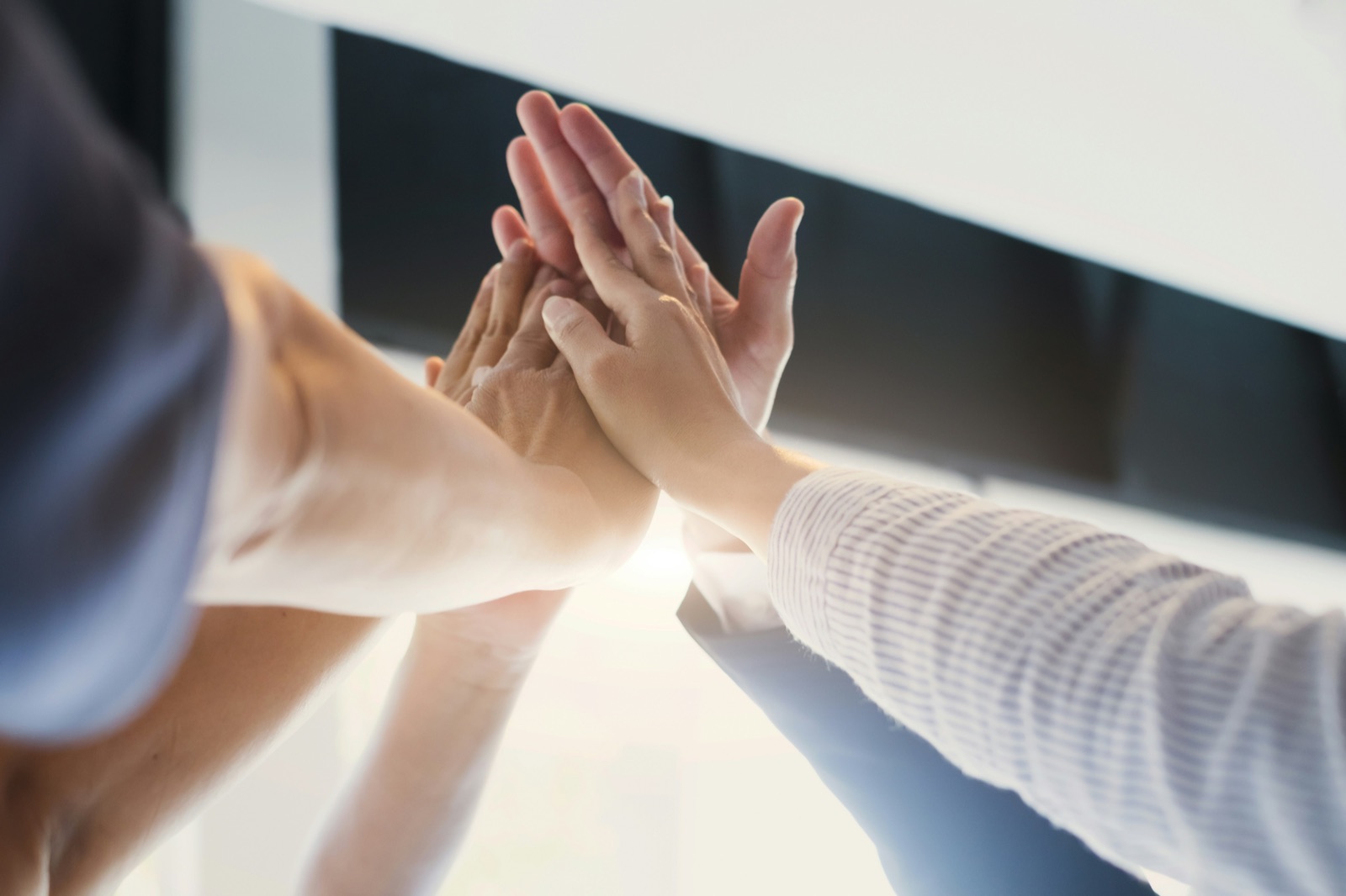 Two hands meeting in a high five